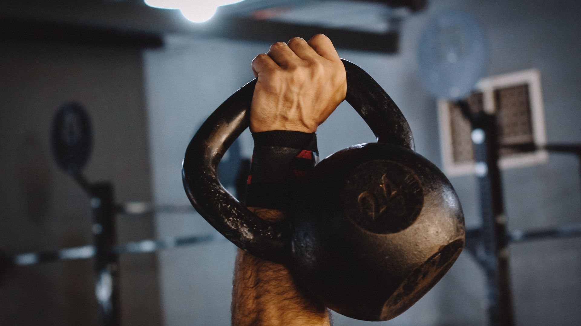 Hand gripping a heavy kettlebell during an intense workout
