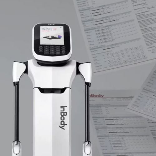 White humanoid robot with calculator head standing next to medical documents